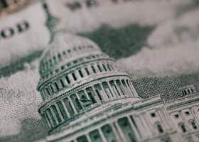 Close-up of the US Capitol illustration on American currency, showing detailed architectural design.